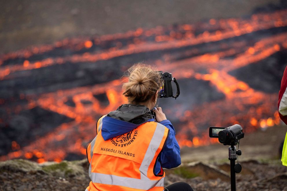 PHOTO: Scientists and students of the department of Geology of the University of Iceland, observe the eruption and take measurements of the Fagradalsfjall volcano near the Litli-Hrutur mountain, southwest of Reykjavik, Iceland, July 10, 2023.