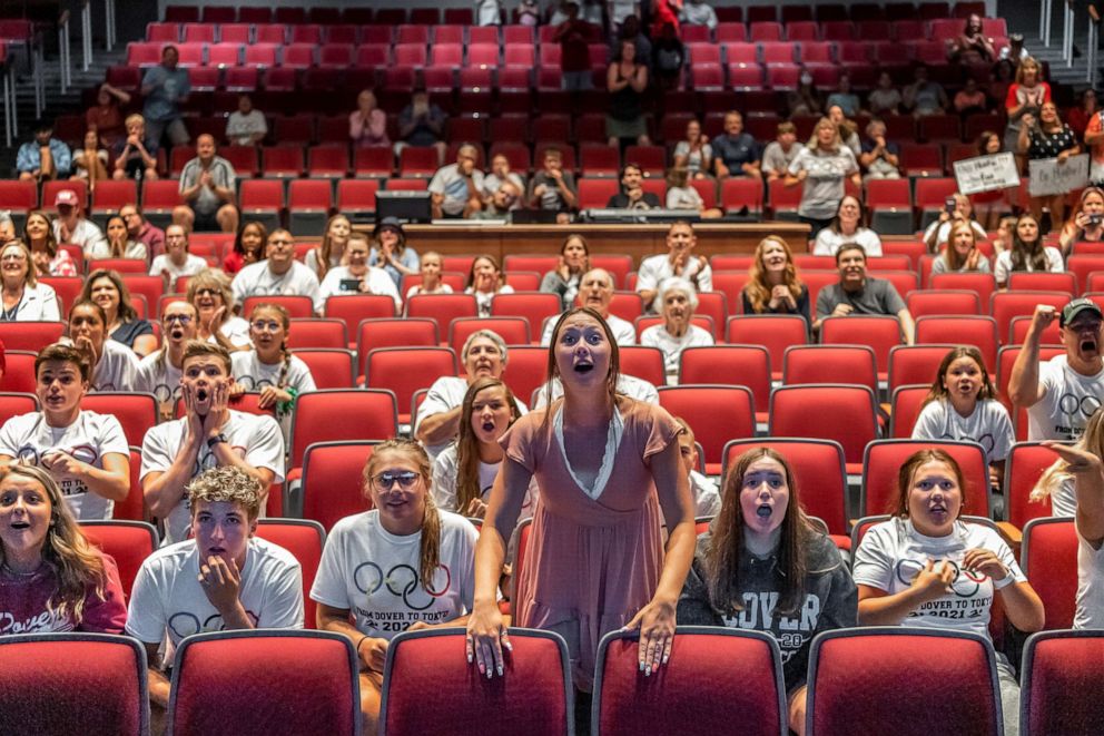 PHOTO: Residents and friends cheer on U.S. swimmer Hunter Armstrong from Dover High School as he competes in the 100m backstroke semi-final race during the 2021 Olympic Games, in Dover, Ohio,  July 25, 2021.