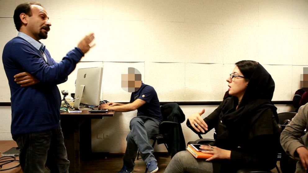 PHOTO: Asghar Farhadi and Azadeh Masihzadeh talking on the sidelines of a workshop at Karnameh institution in Tehran March 2015.