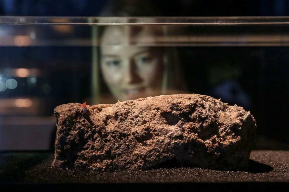 PHOTO: A museum employee poses behind a piece of fatberg, a congealed lump of fat, sanitary napkins, wet wipes, condoms, diapers and similar items found in sewer systems, on display at the Museum of London, Feb. 8, 2018.