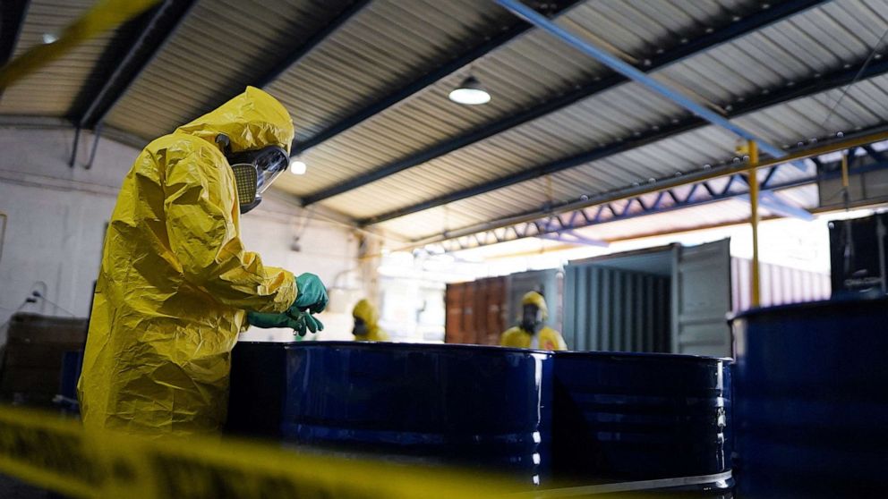PHOTO: Guatemalan anti-narcotic police members take samples from 120 seized barrels of fentanyl in a container that came from Turkey, at a port named Puerto Barrios, Guatemala, in this photo released on March 23, 2023.