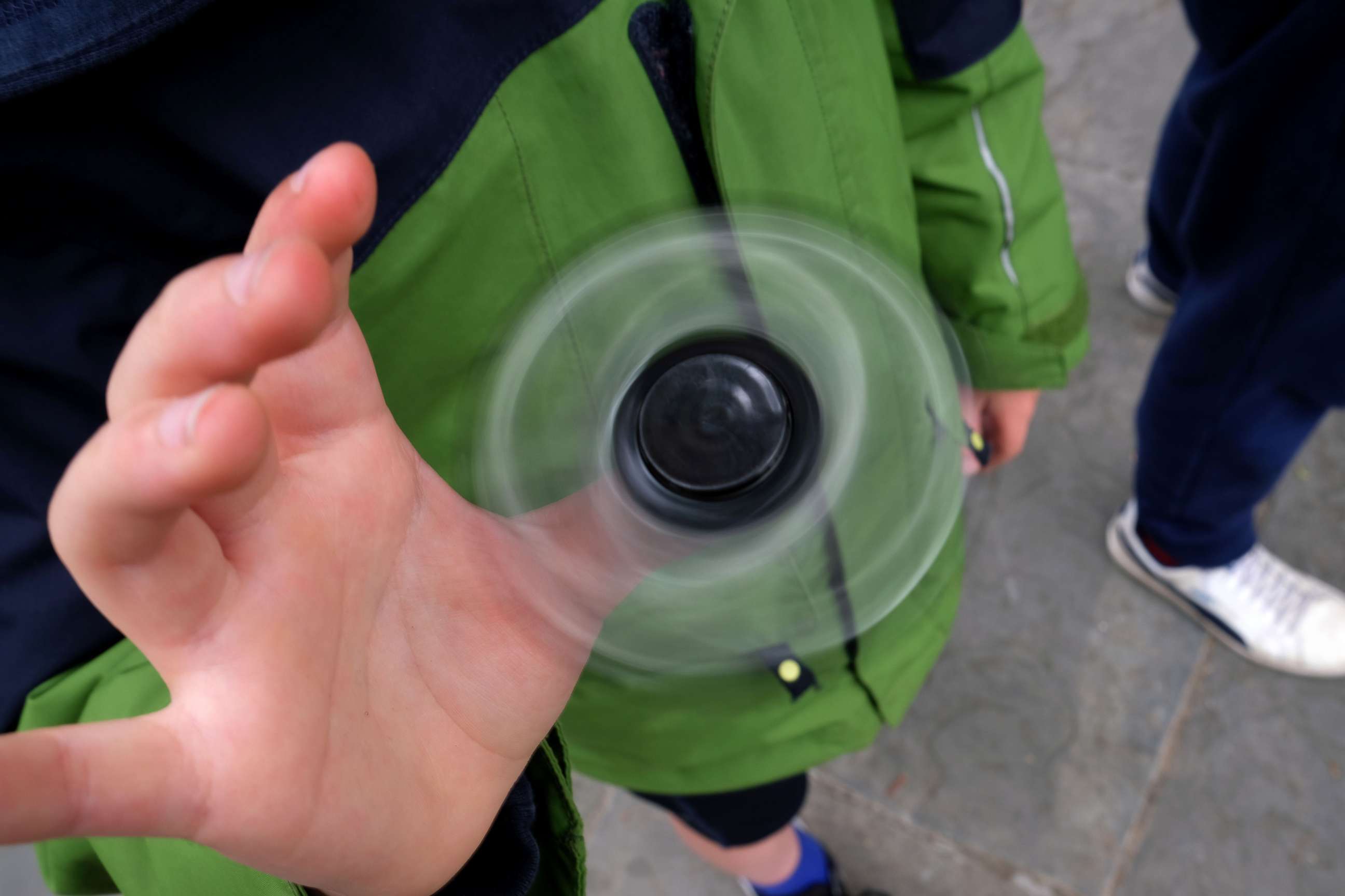 PHOTO: Eight-year-old Tom Wuestenberg plays with a fidget spinner in a park in New York city, May 23, 2017.