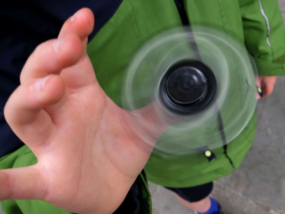 PHOTO: Eight-year-old Tom Wuestenberg plays with a fidget spinner in a park in New York city, May 23, 2017.