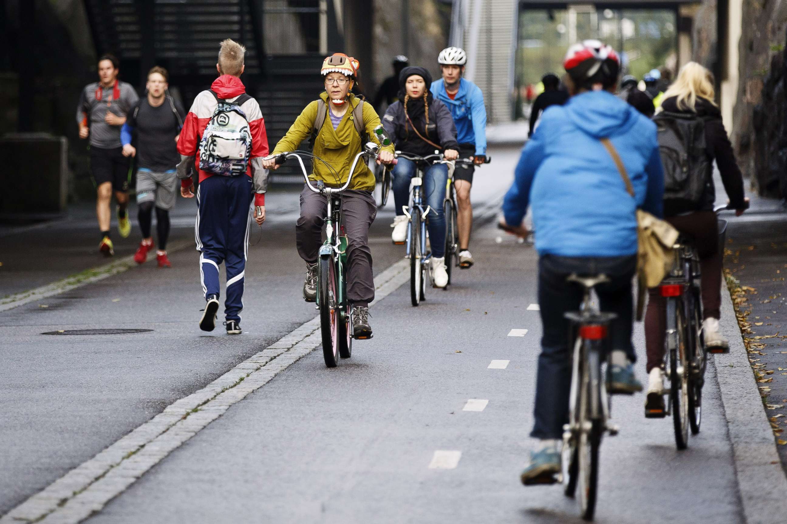 PHOTO: Cyclists and pedestrians pass the "Baana" road that was built on former train tracks and is now reserved for pedestrians and bicycles in Helsinki, Finland, Sept. 18, 2015.