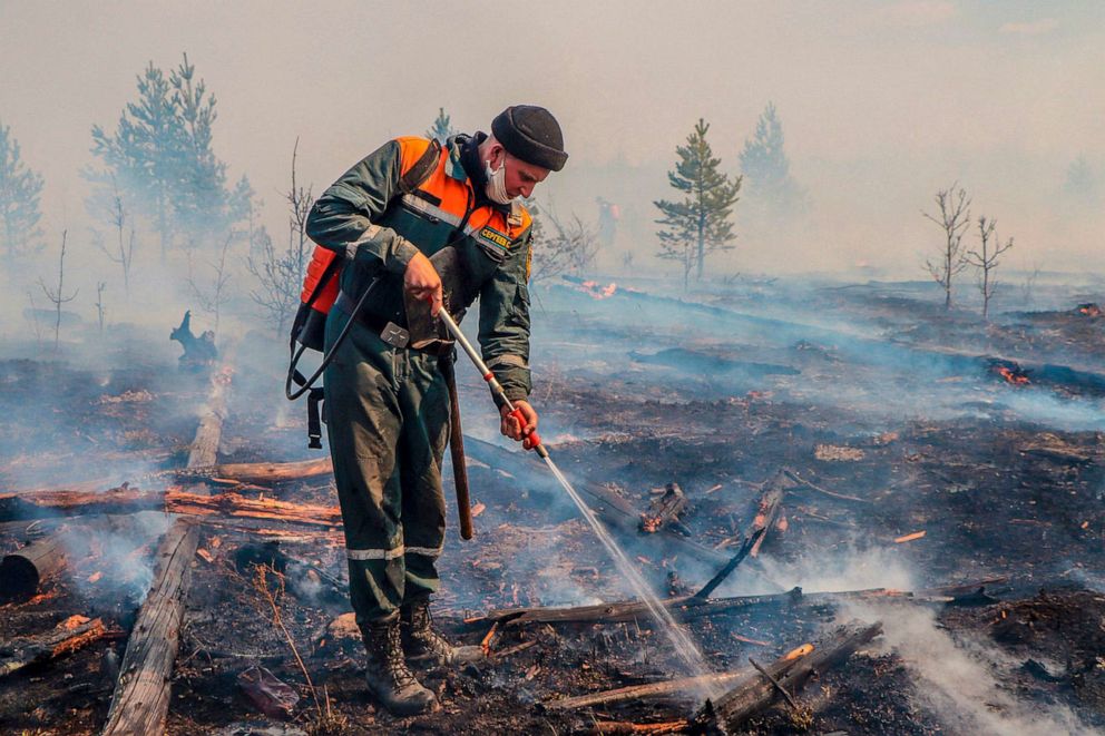 PHOTO: In this handout photo released by Russian Emergency Ministry Press Service, May 10, 2022, A firefighter works at the scene of forest fire in Kurgan region, Russia. 