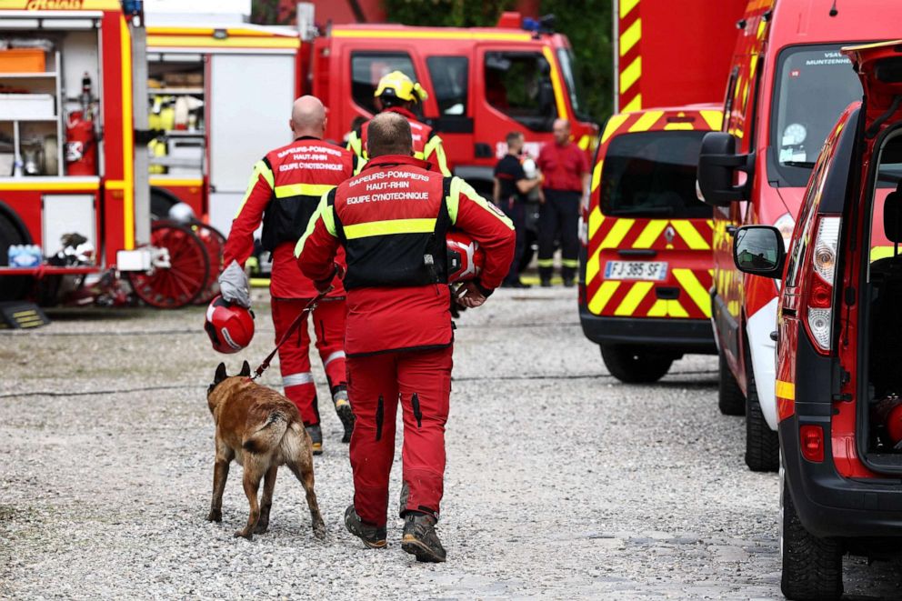 PHOTO: Firefighters and sniffer dogs arrive at the site of a fire which erupted at a home for disabled people in Wintzenheim near Colmar, eastern France, on Aug. 9, 2023.