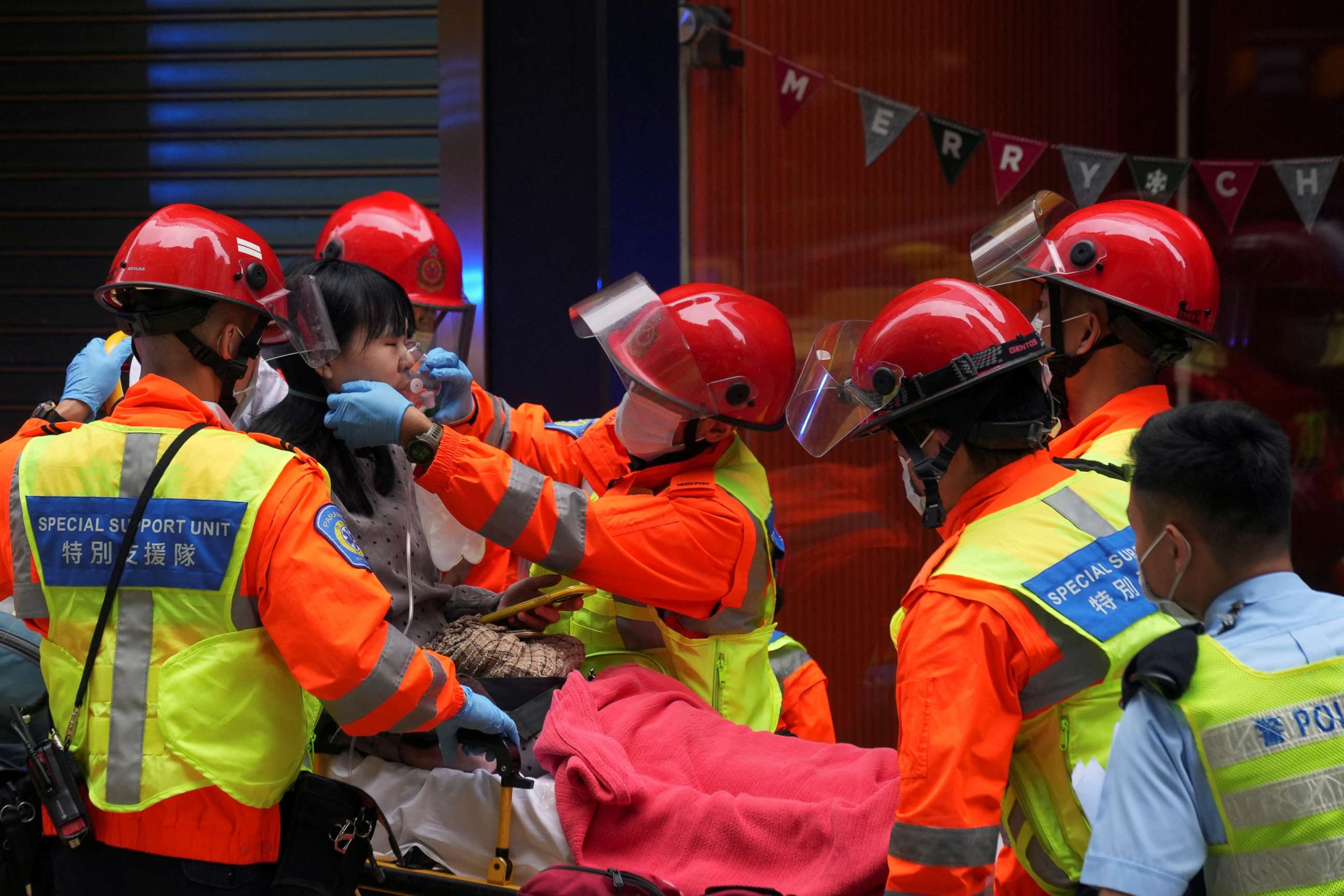 PHOTO: Rescue workers help a person on a stretcher after a fire broke out at the World Trade Centre in Hong Kong, China, on Dec. 15, 2021.