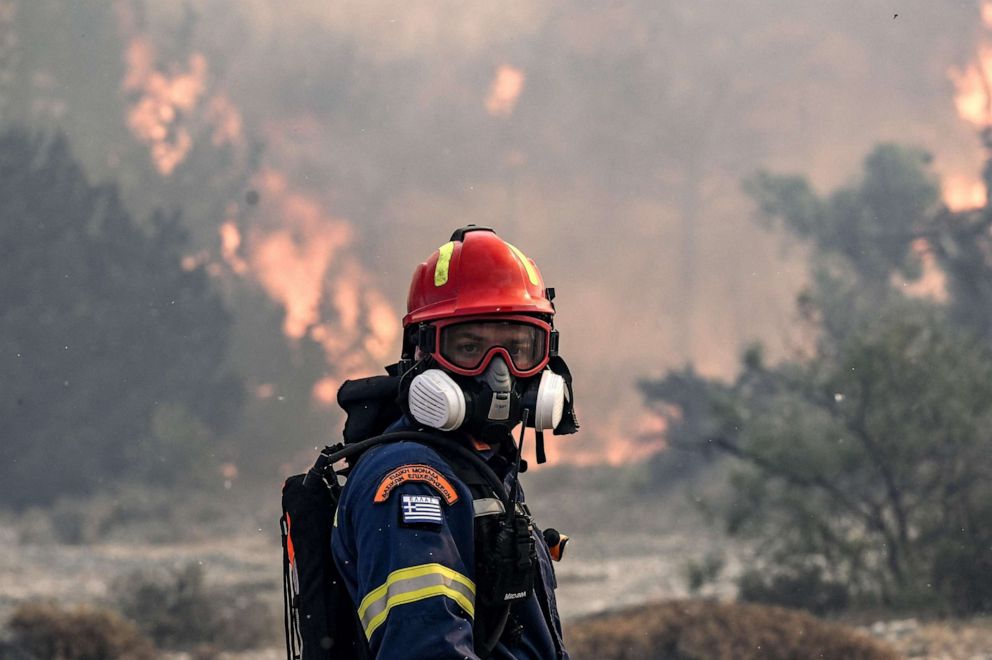 PHOTO: A firefighter looks on during a fire near the village of Vati, just north of the coastal town of Gennadi, in the southern part of the Greek island of Rhodes on July 25, 2023.