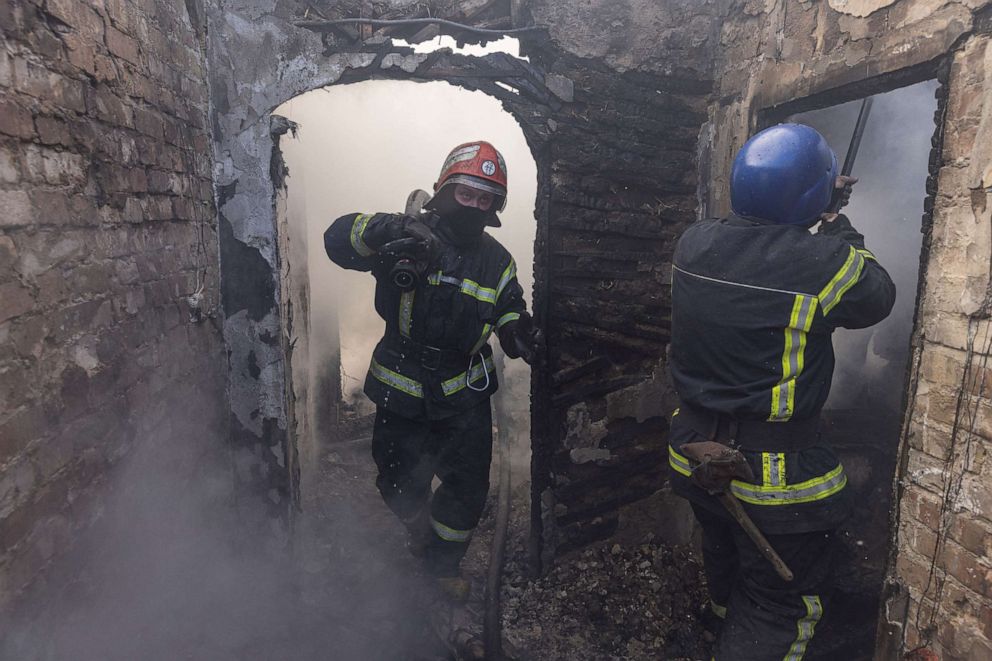 PHOTO: Firefighters work at a residential district that was damaged by shelling in Kyiv, Ukraine, on March 23, 2022, amid Russia's invasion.