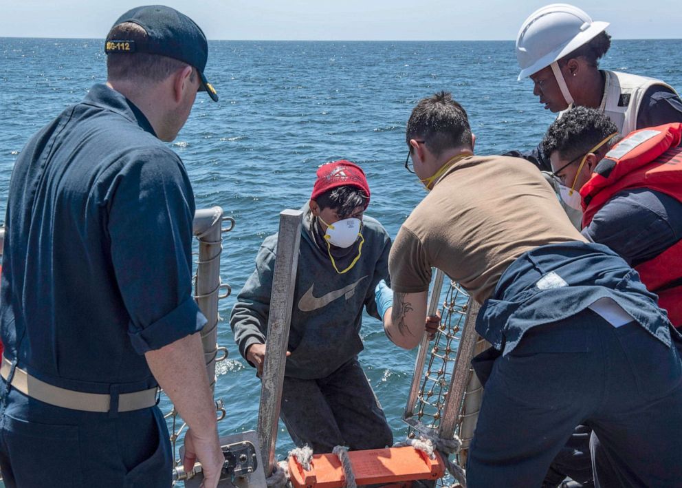 PHOTO: Mariners from a fishing vessel in distress are brought aboard the Arleigh Burke-class guided-missile destroyer USS Michael Murphy for aid after being rescued, July 24, 2019.