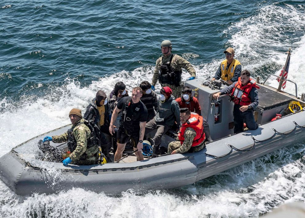 PHOTO: A boarding team from the Arleigh Burke-class guided-missile destroyer USS Michael Murphy bring mariners rescued from a fishing vessel in distress aboard Michael Murphy for aid, July 24, 2019.