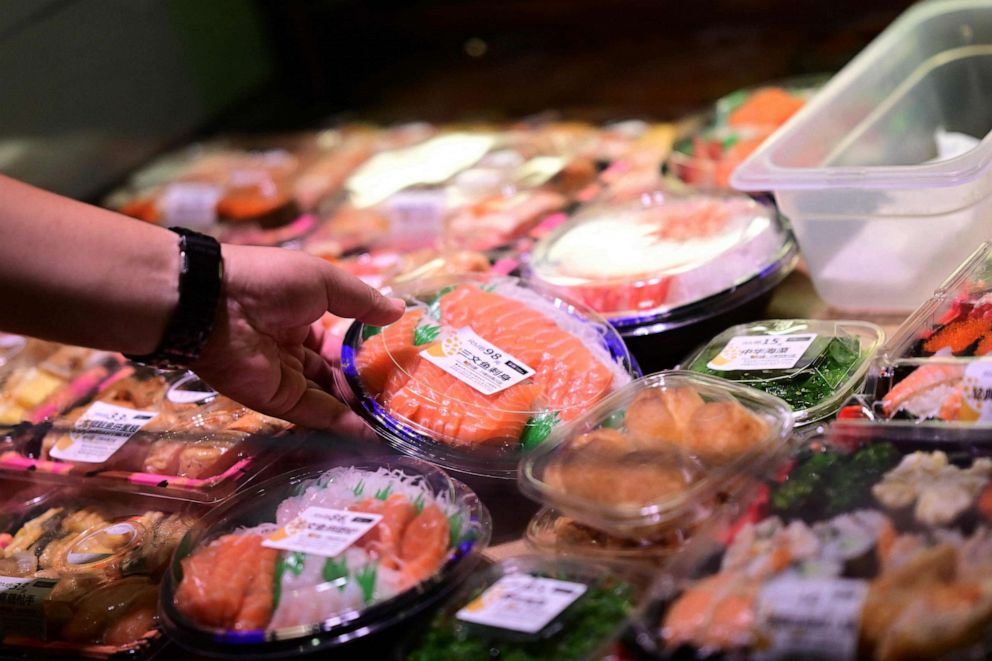 PHOTO: A consumer chooses a dish in a Japanese restaurant in Beijing on August 22, 2023.