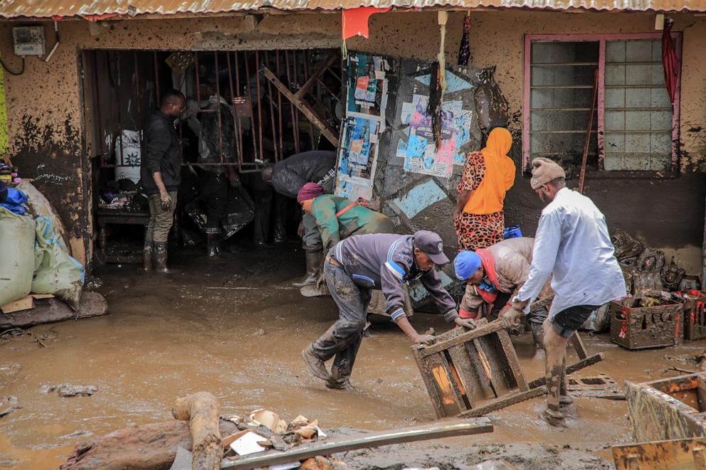 PHOTO: People collect belongings in an area affected by landslides and flooding triggered by heavy rainfall in Katesh, Tanzania, on Dec. 3, 2023. 