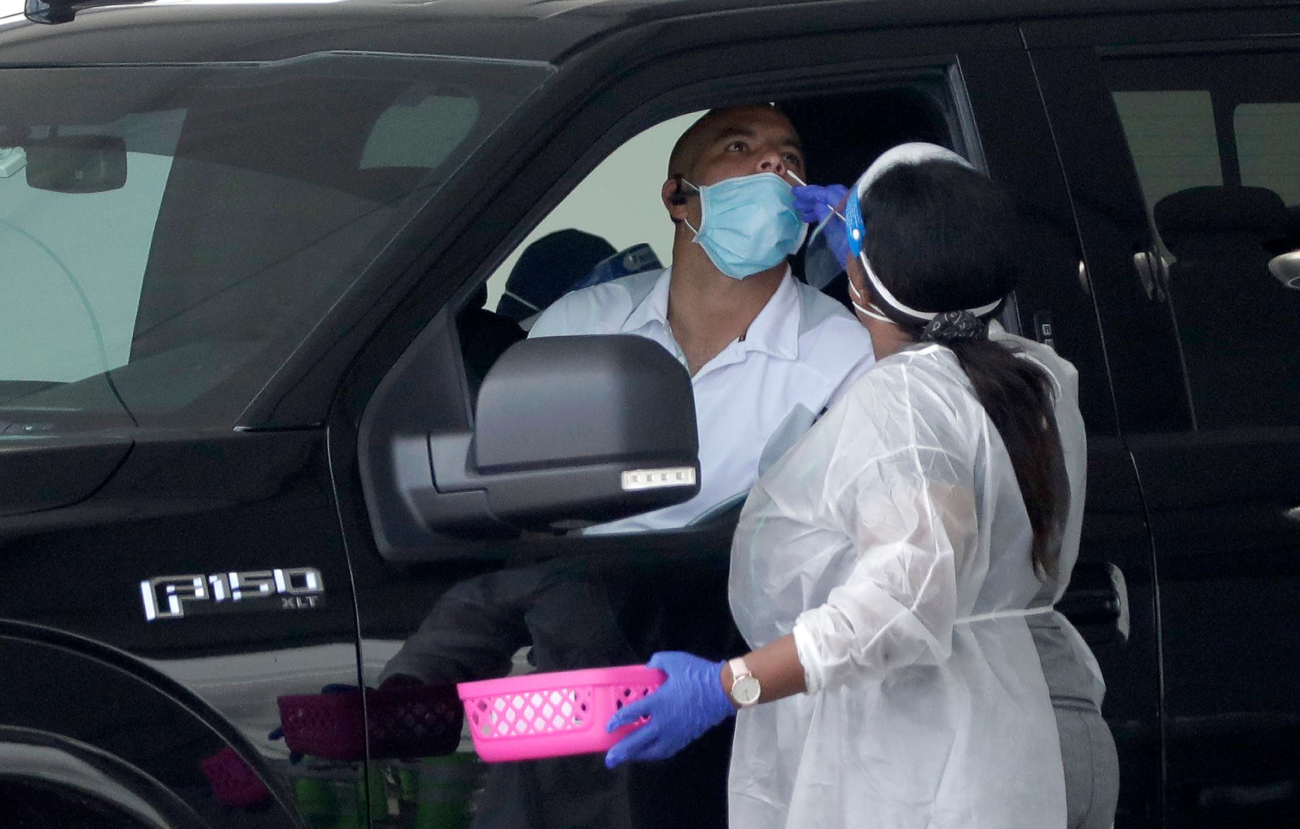 PHOTO: A healthcare worker performs an antigen test, Aug. 5, 2020, at a COVID-19 testing site outside Hard Rock Stadium in Miami Gardens, Fla.