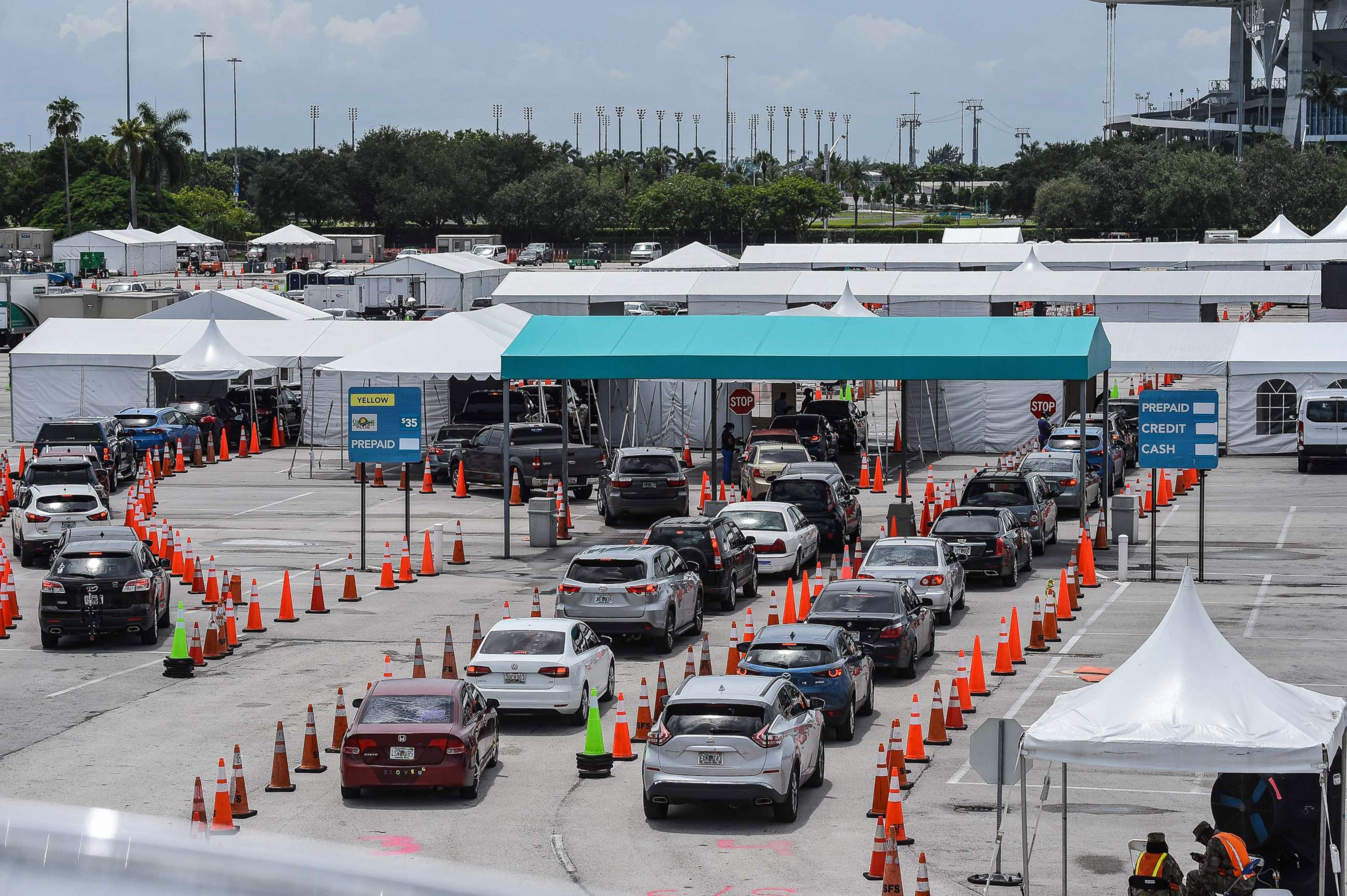 PHOTO: Cars line up at a rapid antigen coronavirus testing site at Hard Rock Stadium in Miami Gardens near Miami, Aug. 5, 2020.