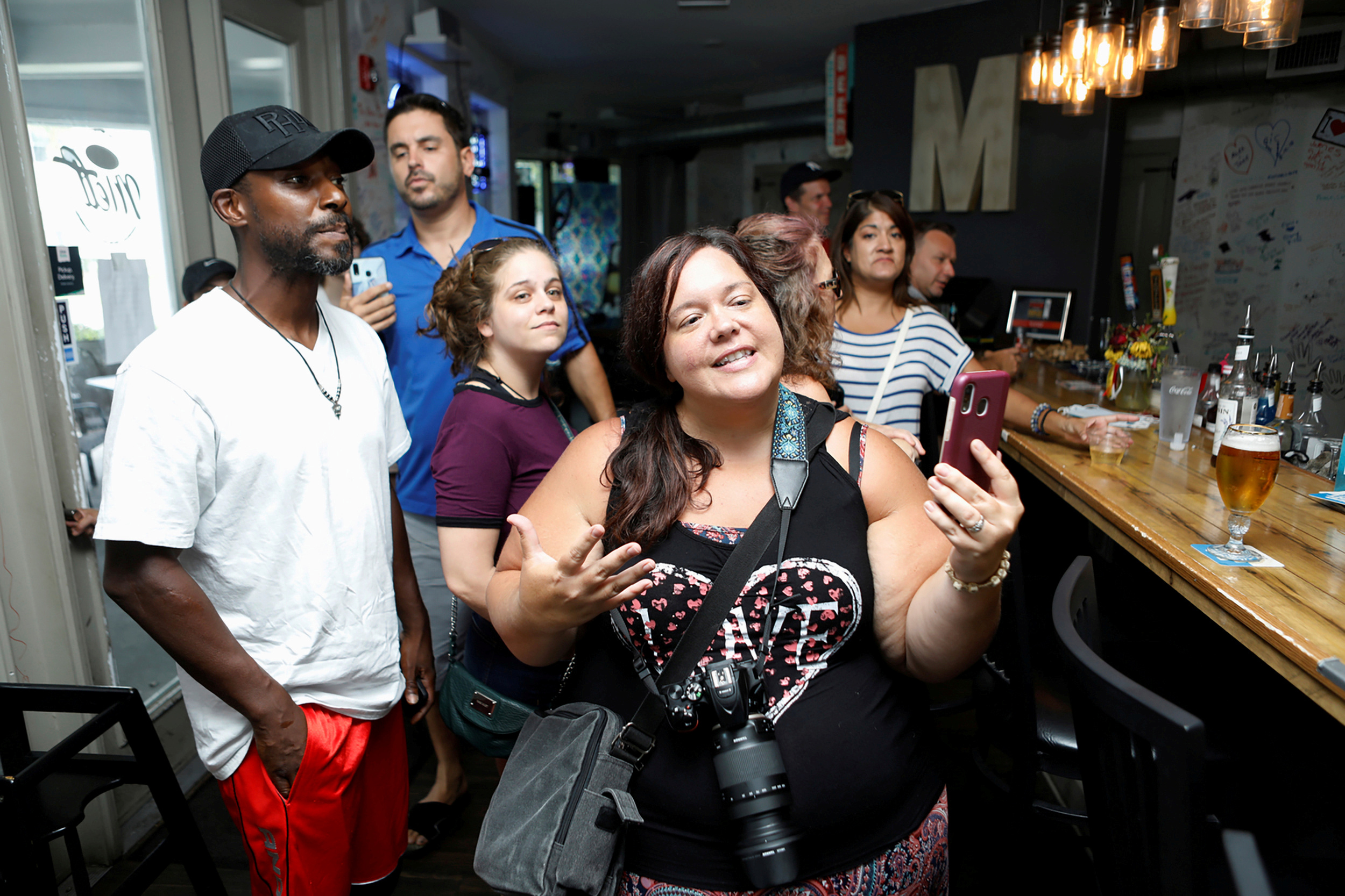 PHOTO: People gather at the 33 & Melt restaurant "maskless" rally and dinner to protest mandatory face mask restrictions during the coronavirus disease (COVID-19) pandemic in Windermere, Florida, July 11, 2020.