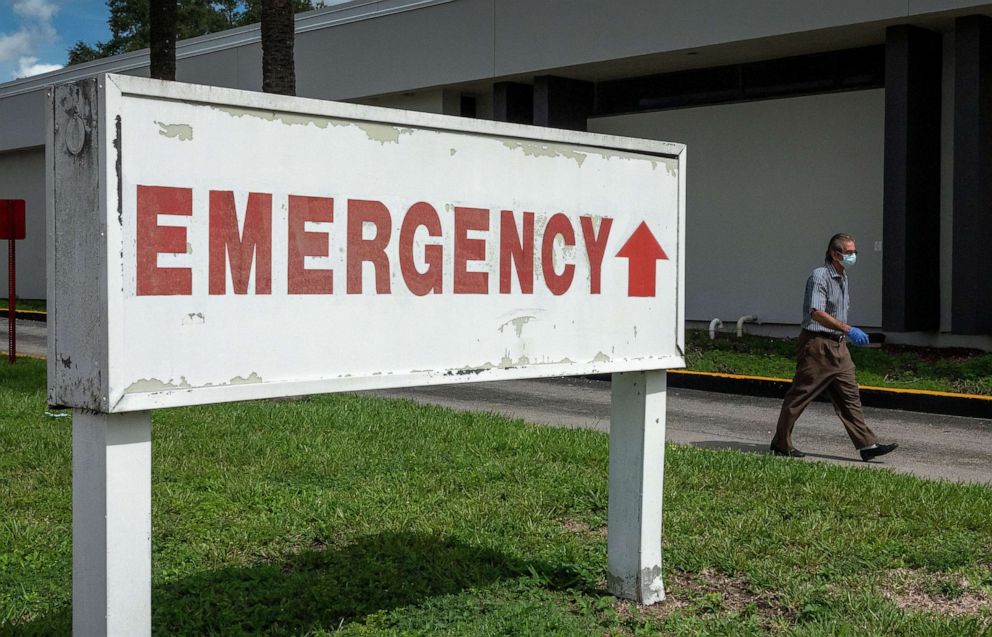 PHOTO: A man walks past an emergency room sign at the Hialeah Hospital in Hialeah, Fla., June 22, 2020.