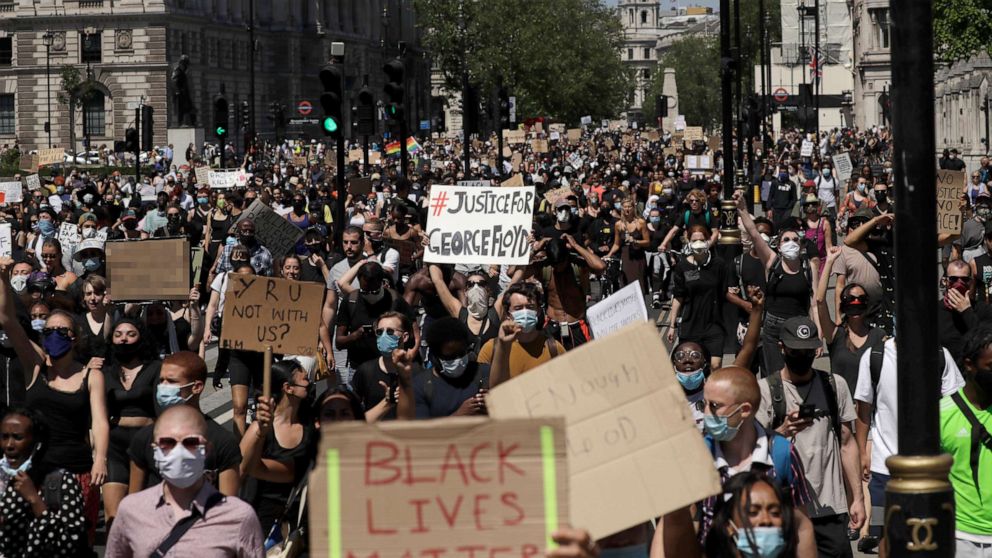 PHOTO: People march through Parliament Square in central London, May 31, 2020, to protest against the recent killing of George Floyd by police officers in Minneapolis.