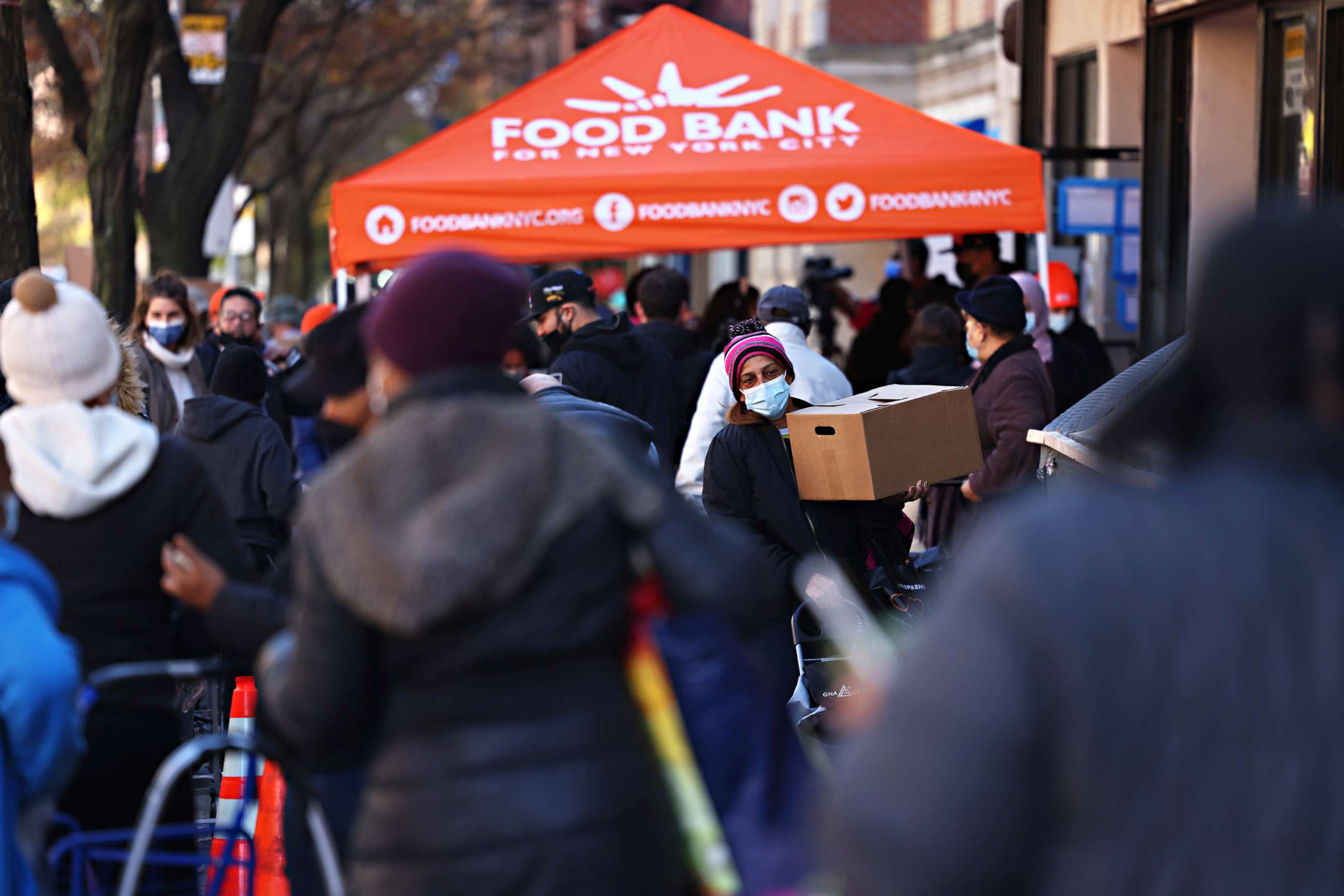 PHOTO: People wait in line for a Thanksgiving food distribution event at Food Bank For New York City in the Harlem neighborhood of New York City, on Nov. 16, 2020.