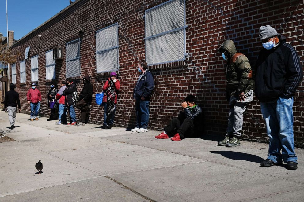 PHOTO: People wait in line to receive food at a food bank on April 28, 2020, in the Brooklyn, New York.