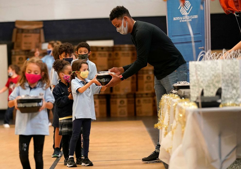 PHOTO: Colorado Rockies pitcher Yency Almonte passes out Thanksgiving meals to youth at the Boys & Girls Club of Miami-Dade County in Florida, Nov. 19, 2020. 