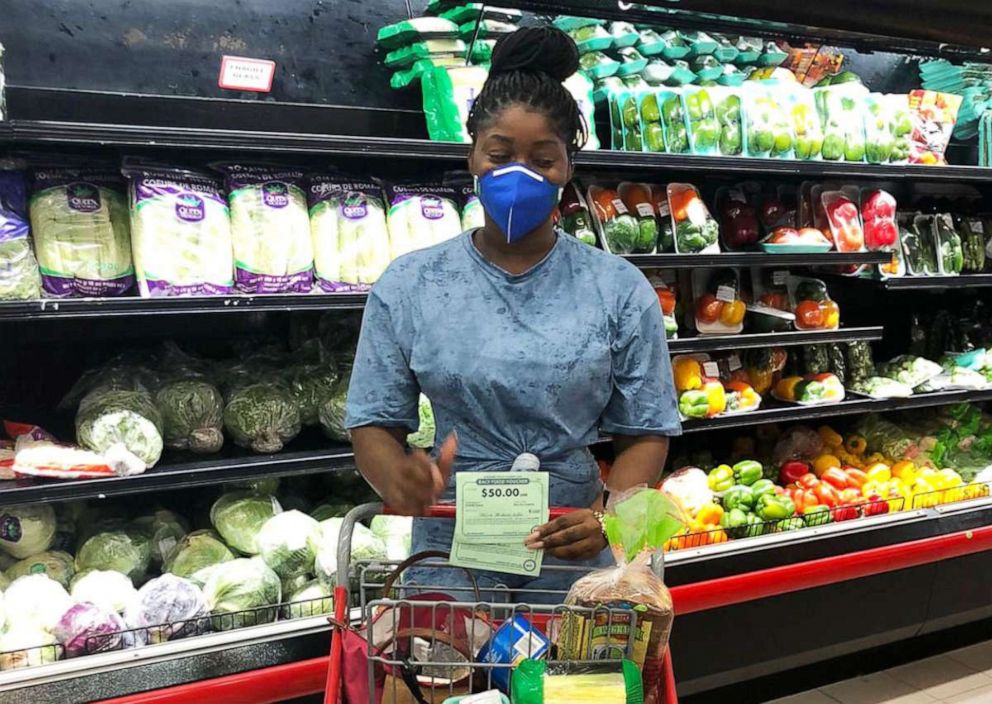 PHOTO:  A woman shops using her COVID-19 Food Vouchers from the Blanchards Anguilla Children’s Fund.
