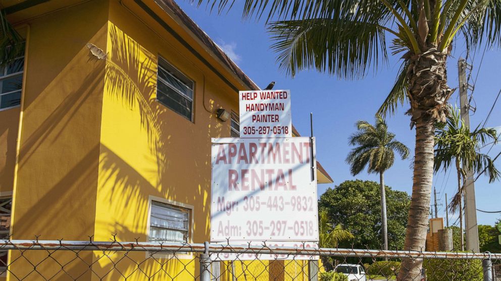 PHOTO: "For Rent" and "Help Wanted" signs are posted outside an apartment building in Miami, April 14, 2021. 