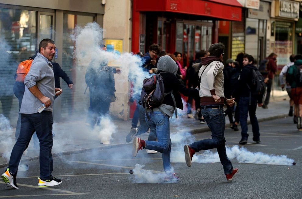 PHOTO: Protesters run away from tear gas during a demonstration on Act 45 (the 45th consecutive national protest on Saturday) of the yellow vests movement in Paris, France, September 21, 2019.