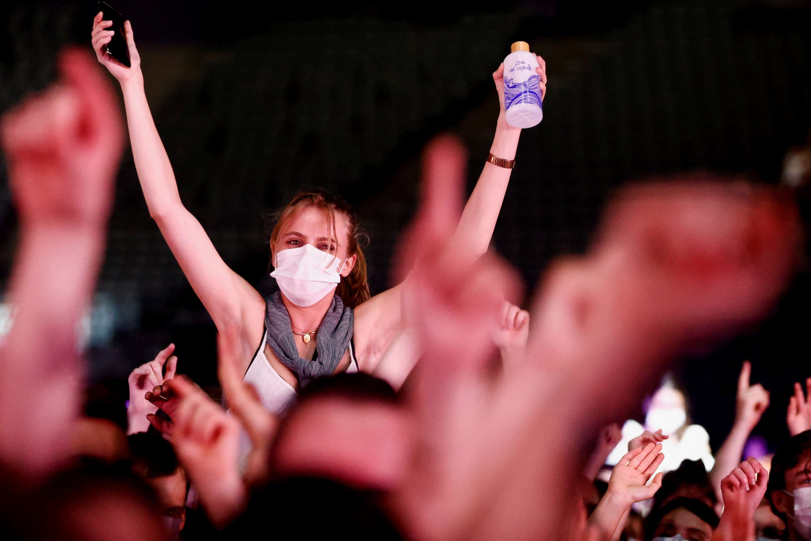 PHOTO: People attend the massive experimental concert "Ambition Live Again," organized to assess health risks associated with resuming large-scale public gatherings since the beginning of the COVID-19 pandemic, at Paris Accor Arena in Paris, May 29, 2021.