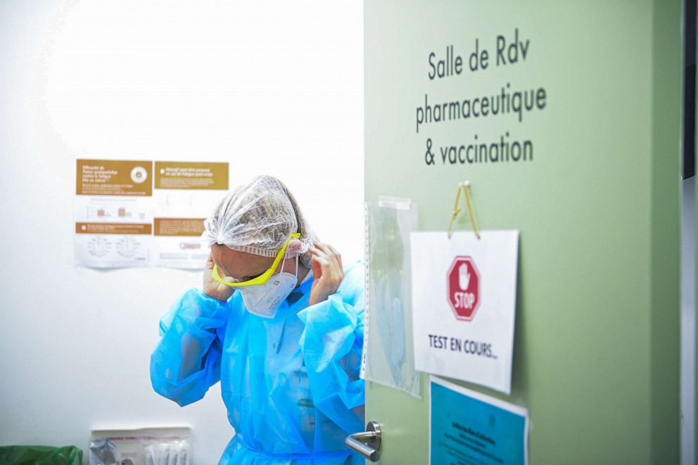 PHOTO: A pharmacy employee prepares prior to conducting a Rapid Antigen COVID-19 test, in Paris, Oct. 30, 2020.