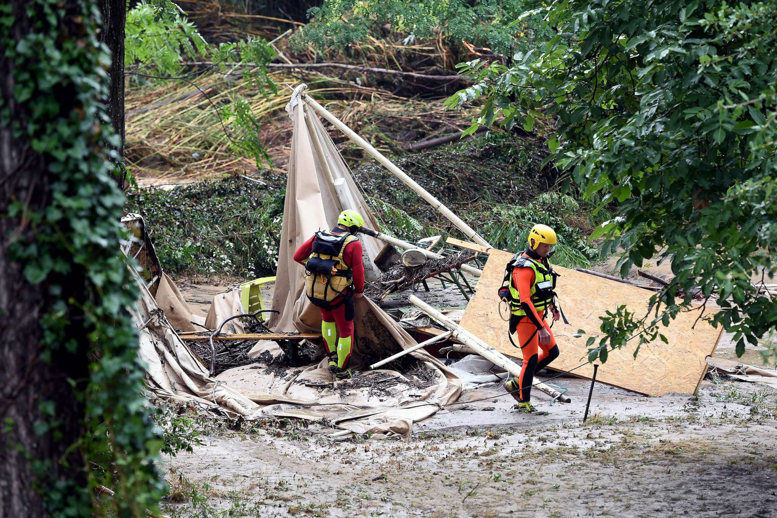 PHOTO: Rescuers walk past a damaged tent in a flooded camping as storms and heavy rains sweep across France, Aug. 9, 2018, in Saint-Julien-de-Peyrolas, southern France.