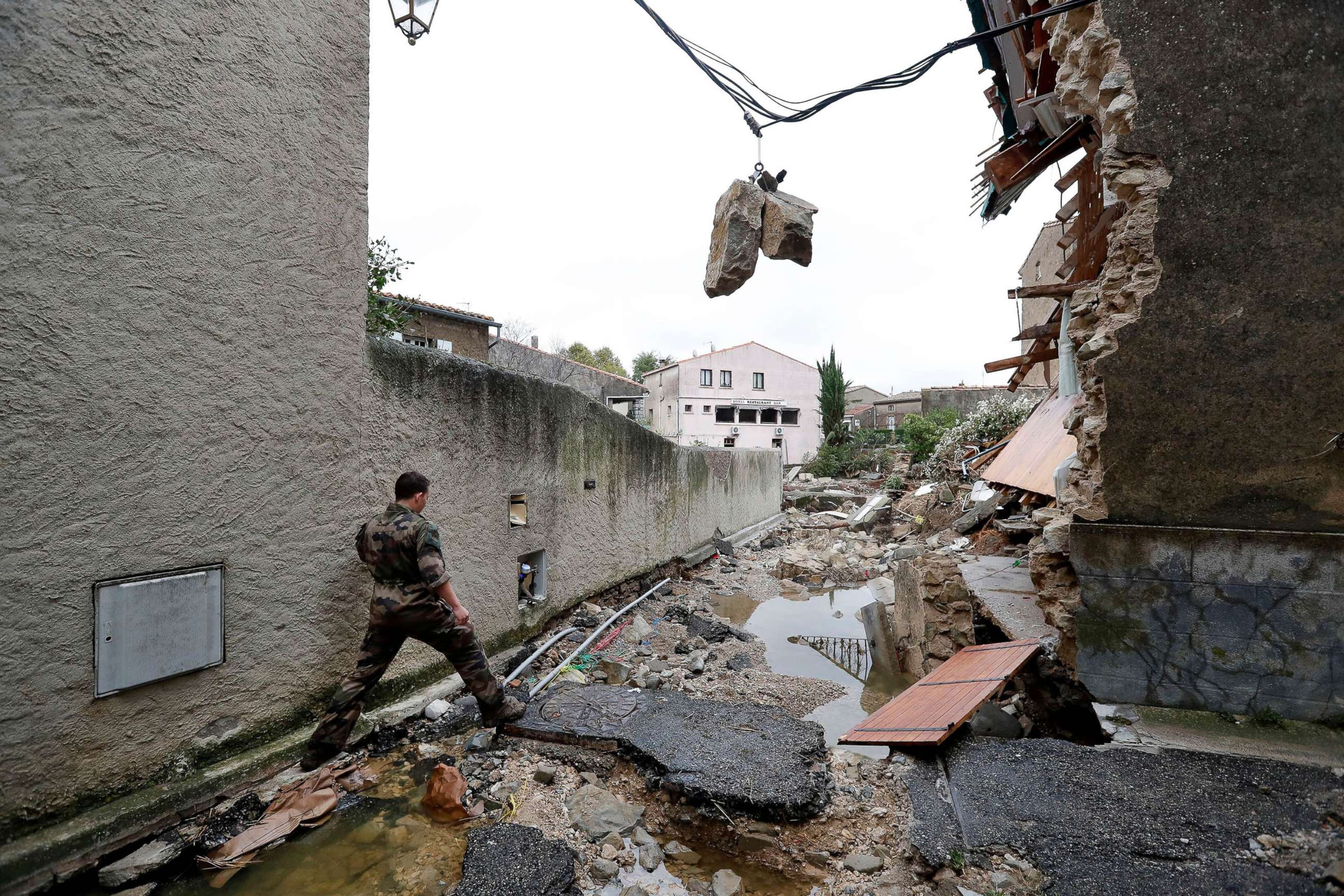 PHOTO: A military officer walks through a damaged street due to heavy rain falls, flash floods and violent storm that hit Aude department overnight in Villegailhenc, France, Oct. 15, 2018.
