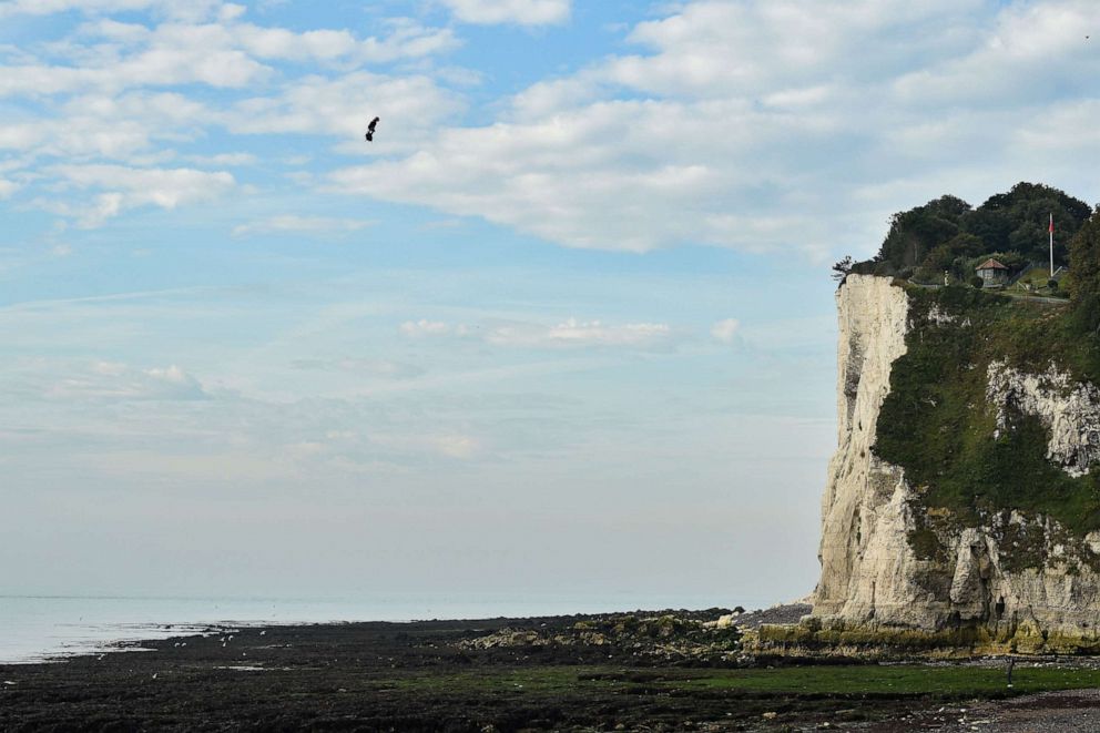 PHOTO: Franky Zapata on his jet-powered flyboard flies past the belfry of the city hall of Calais after he took off from Sangatte, northern France, on Aug. 4, 2019, during his attempt to fly across the 22-mile English Channel crossing in 20 minutes.