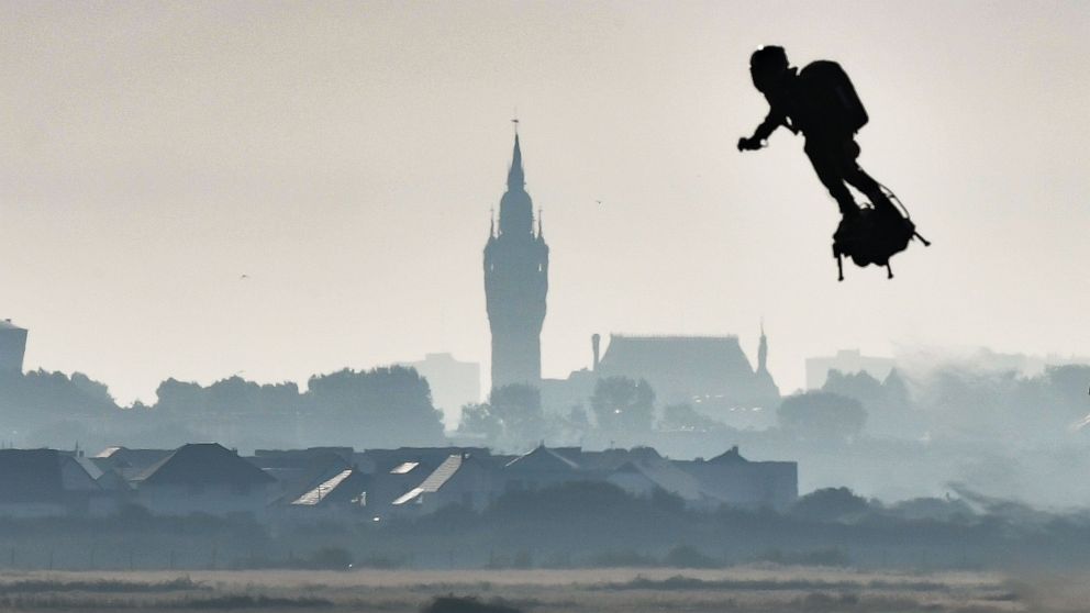 PHOTO: Franky Zapata on his jet-powered "flyboard" flies past the belfry of the city hall of Calais after he took off from Sangatte, northern France, on Aug. 4, 2019, during his attempt to fly across the 22-mile English Channel crossing in 20 minutes.