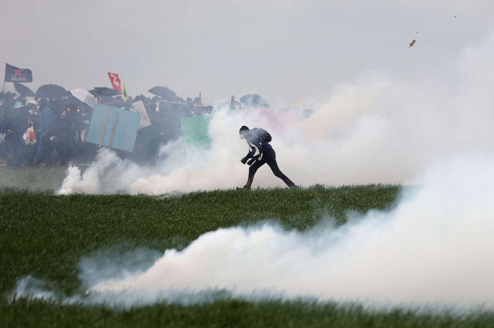 PHOTO: Protestors clash with French gendarmes during a demonstration called by the collective "Bassines non merci", to protest against the construction of a new water reserve for agricultural irrigation, in Sainte-Soline, France, Mar. 25, 2023.
