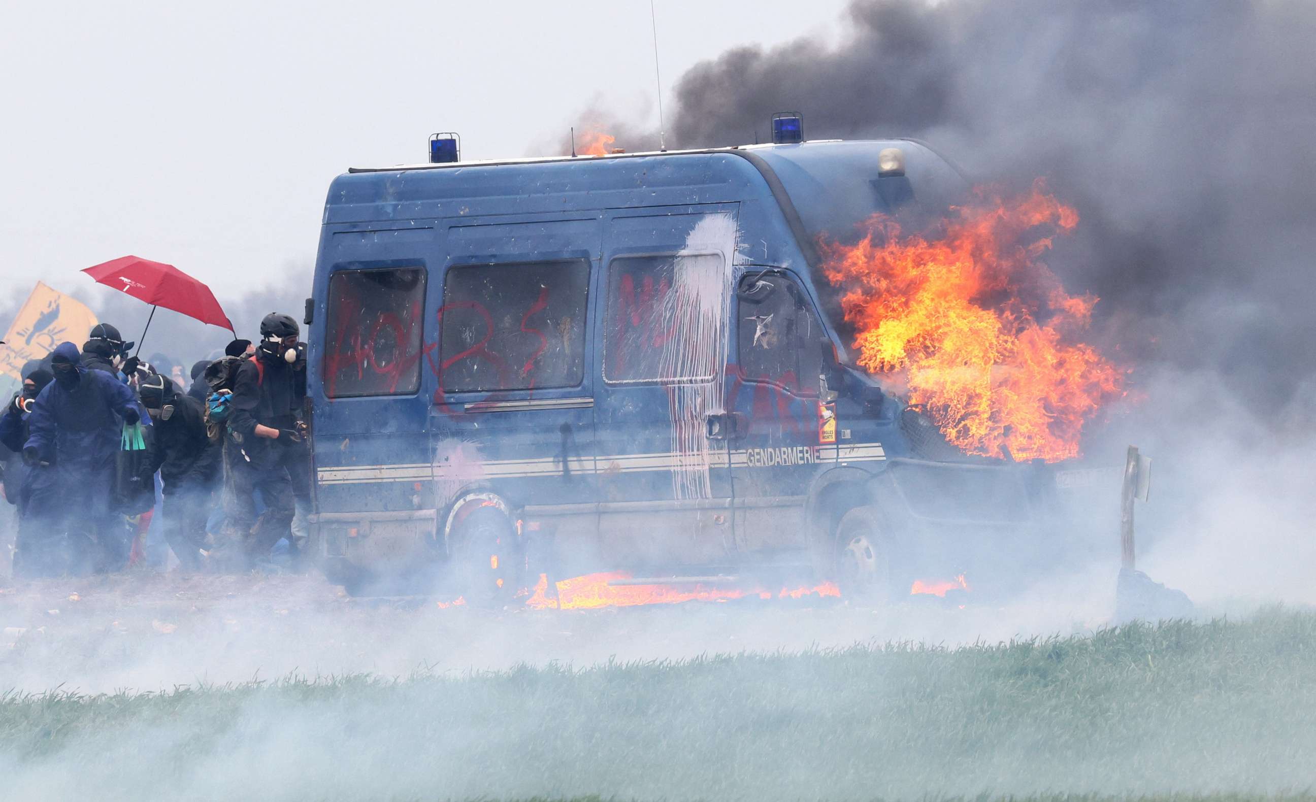 PHOTO: A police vehicle burns as protesters attend a demonstration called by the collective "Bassines Non Merci" on the construction site of new water storage infrastructure for agricultural irrigation in Sainte-Soline, France Mar. 25, 2023.