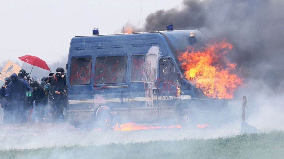 PHOTO: A police vehicle burns as protesters attend a demonstration called by the collective "Bassines Non Merci" on the construction site of new water storage infrastructure for agricultural irrigation in Sainte-Soline, France Mar. 25, 2023.
