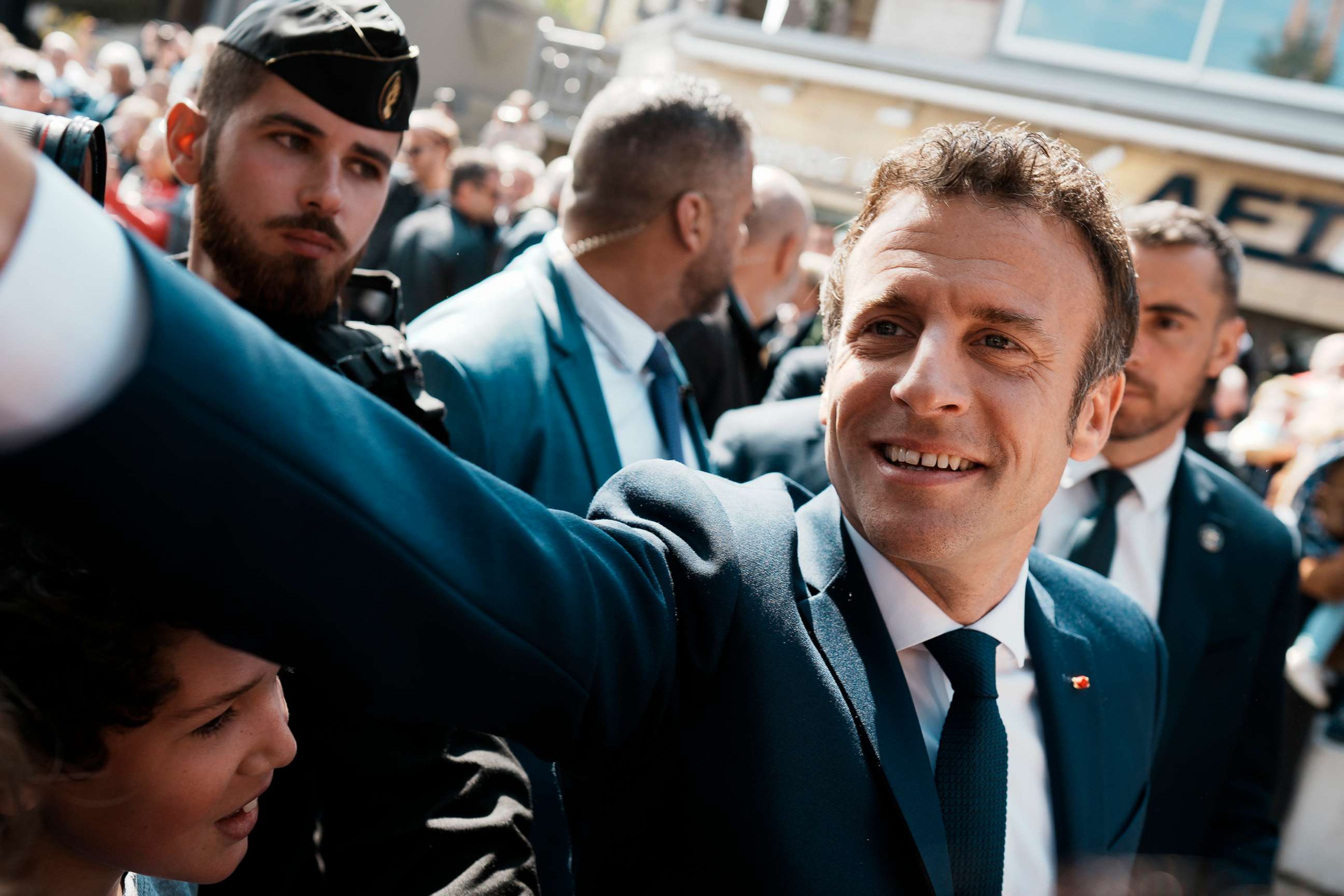 PHOTO: French President and centrist candidate Emmanuel Macron shakes hands with well-wishers as he heads to the polling station in Le Touquet, northern France, April 24, 2022. 