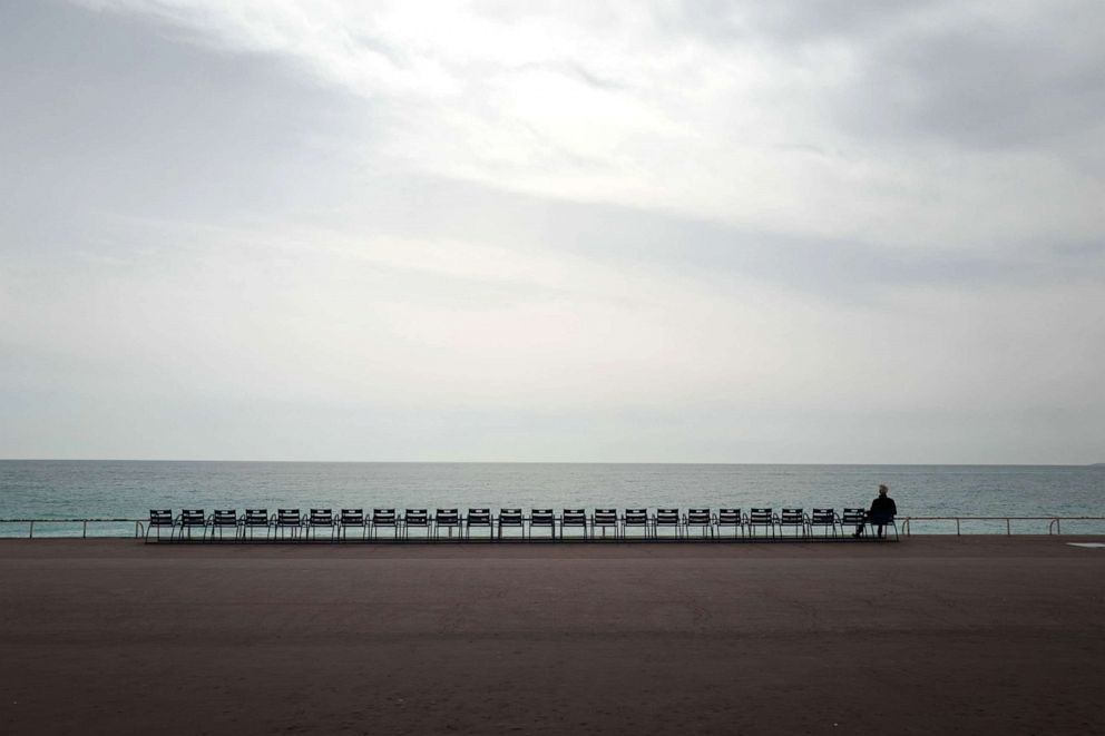 PHOTO: A man looks at the Mediterranean sea on the "Promenade des Anglais" in the French Riviera city of Nice, as a strict lockdown requiring most people in France to remain at home came into effect on March 17, 2020. 