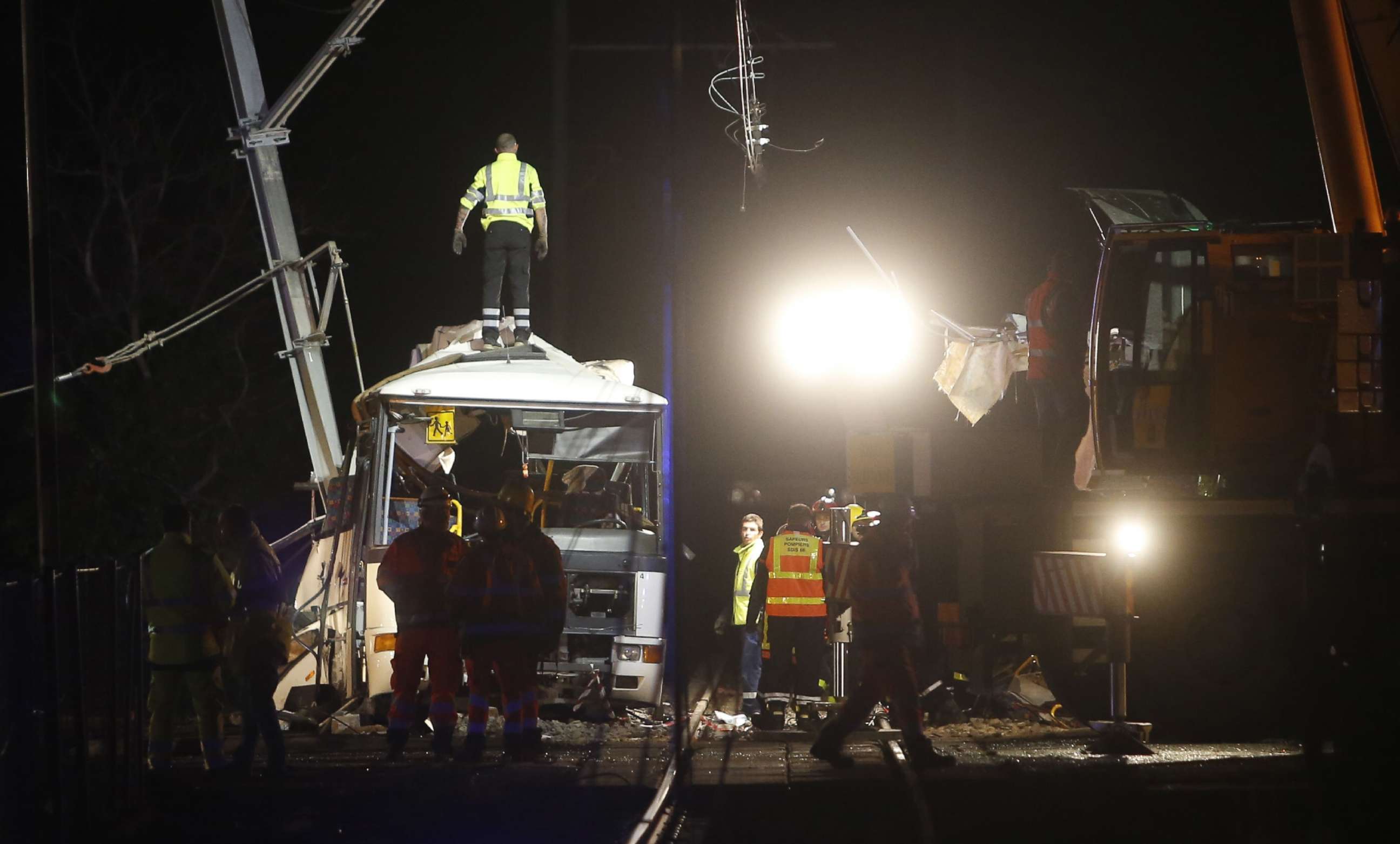 PHOTO: Firefighters and police work at the site of an accident in Millas, near Perpignan, southern France, on Dec. 14, 2017, after a train crashed into a school bus at a level crossing.