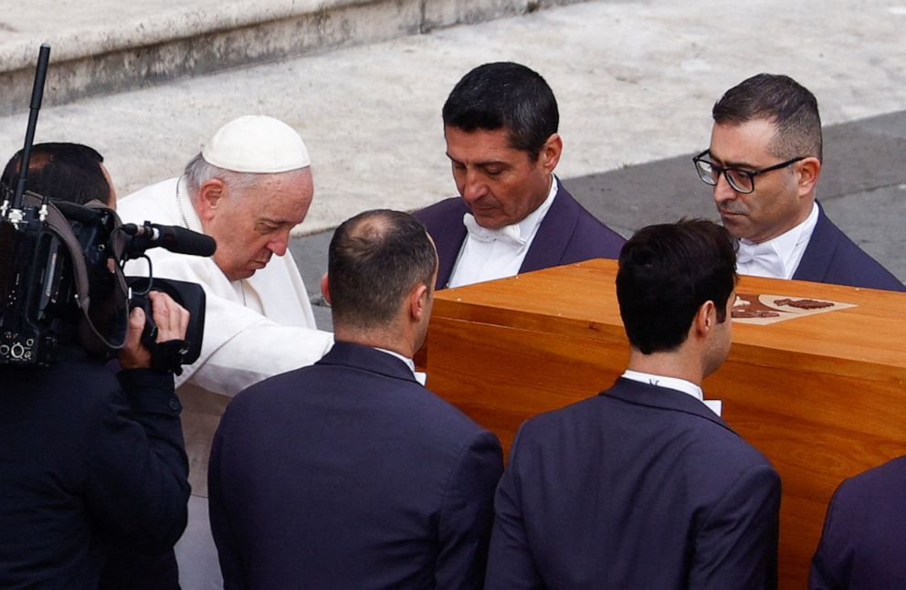 PHOTO: Pope Francis touches the coffin of former Pope Benedict XVI during his funeral, in St. Peter's Square, Vatican, January 5, 2023.