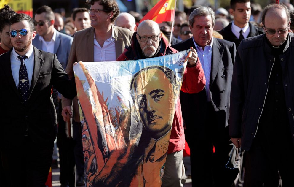 PHOTO: A man holds a drawing of Spanish dictator Gen. Francisco Franco as they gather outside Mingorrubio's cemetery, outskirts of Madrid, Thursday, Oct. 24, 2019.