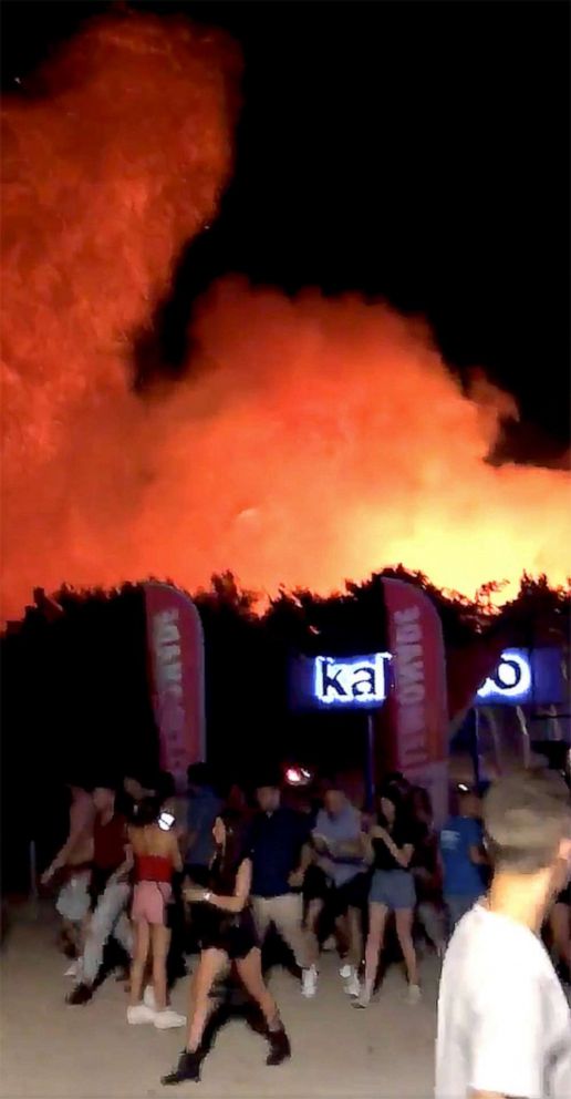 PHOTO: People walk following a fire during the Fresh Island Festival in Novalja, Croatia July 16, 2019, in this still image taken obtained from social media video.