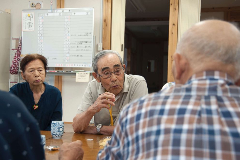 PHOTO: Seimei Sasaki (center), a 92-year-old resident, enjoys chatting with his fellow senior residents after a morning workout at a community center of the Ushigoe Housing Complex in Minamisoma, Fukushima.