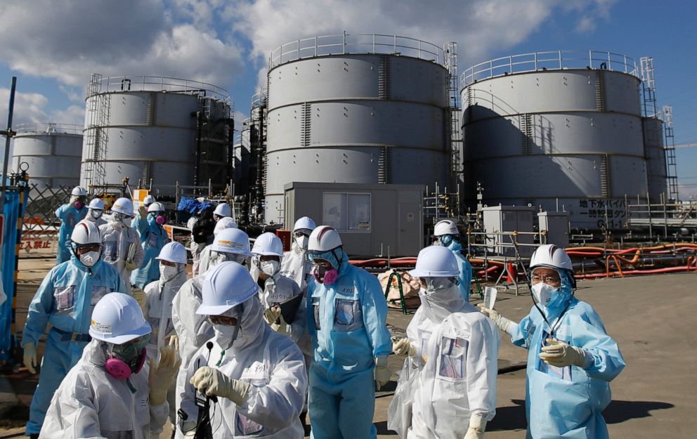 PHOTO: In this Feb. 10, 2016, file photo, media and employees receive a briefing from Tokyo Electric Power Co. in front of storage tanks for radioactive water at the Fukushima Dai-ichi nuclear power plant in Okuma, Fukushima Prefecture, Japan.