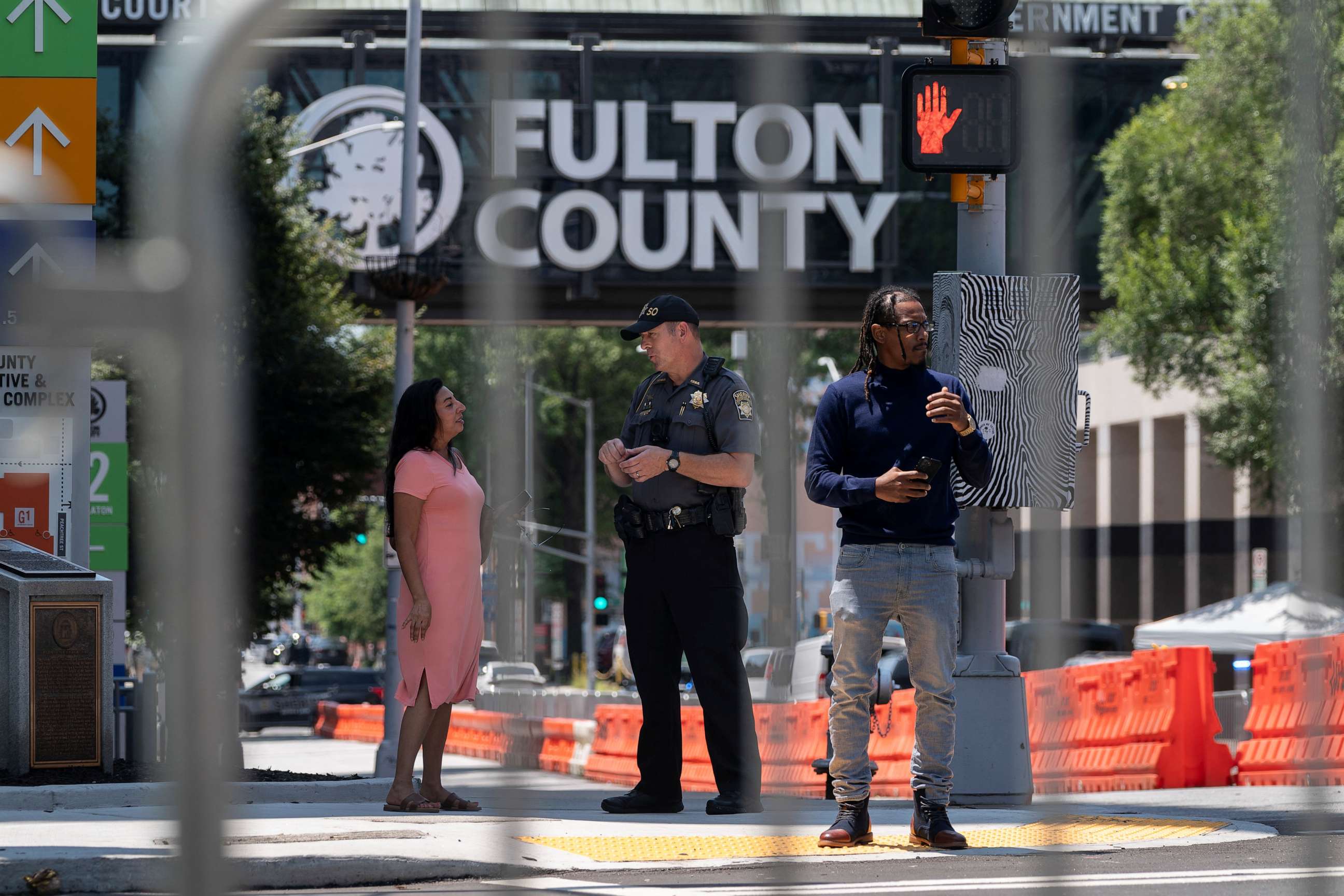 PHOTO: A Sheriff's deputy stands outside after the Fulton County Sheriff ordered roads to be closed as officials tighten security around the Lewis R. Slaton Courthouse, in Atlanta, Georgia, U.S. August 7, 2023.