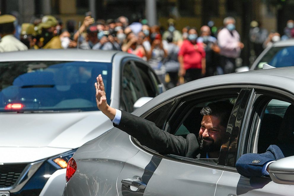 PHOTO: Chilean President-elect Gabriel Boric waves to supporters as he arrives to La Moneda presidential palace for a meeting with current President Sebastian Pinera in Santiago, Chile, Dec. 20, 2021.