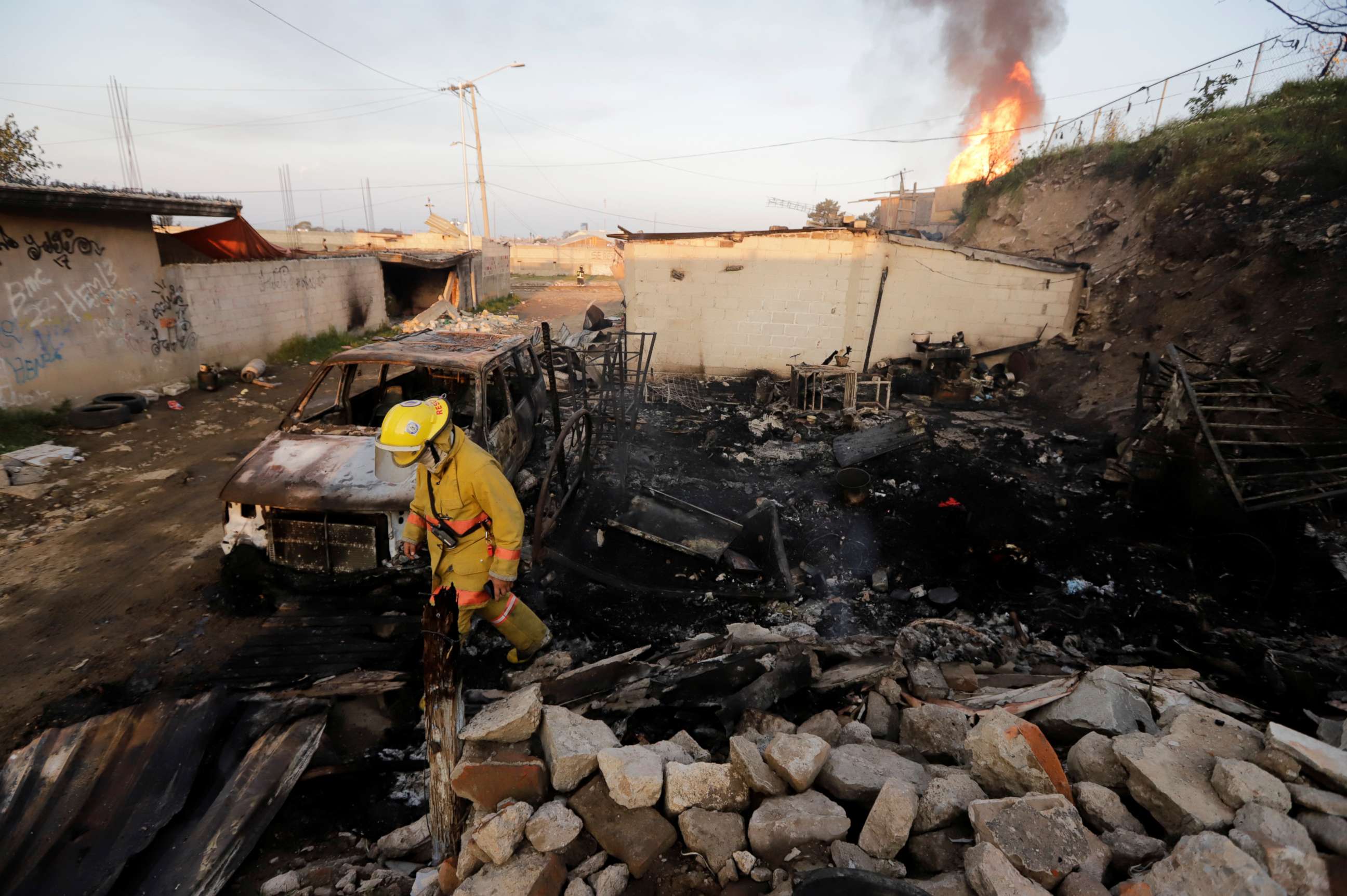 PHOTO: A firefighter walks at an area affected by the explosion of a gas leak caused by a pipeline theft, in the San Pablo Xochimehuacan neighborhood in Puebla, Mexico October 31, 2021. 