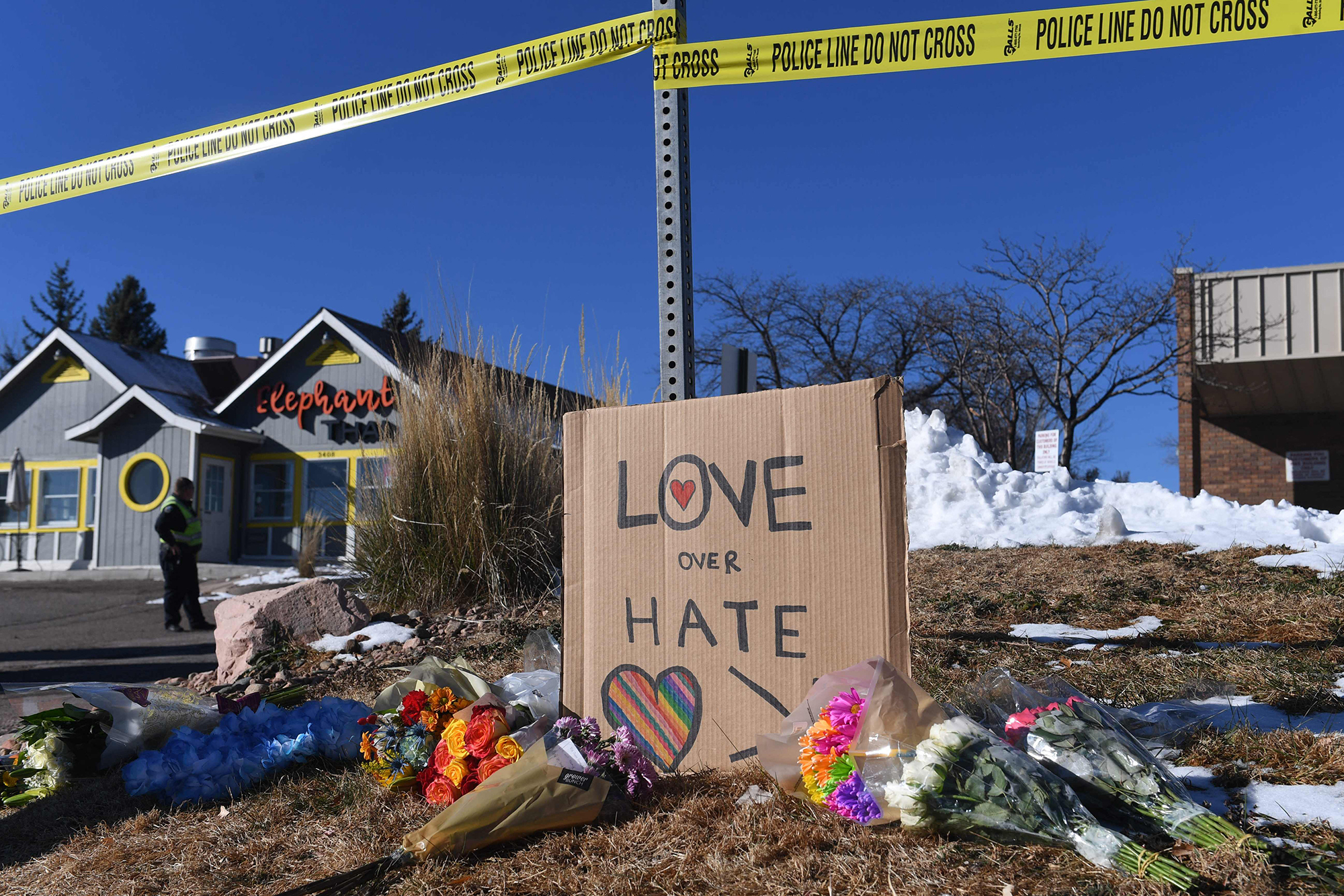 PHOTO: Bouquets of flowers and a sign reading "Love Over Hate" are left near Club Q, an LGBTQ nightclub in Colorado Springs, Colo., Nov. 20, 2022. 