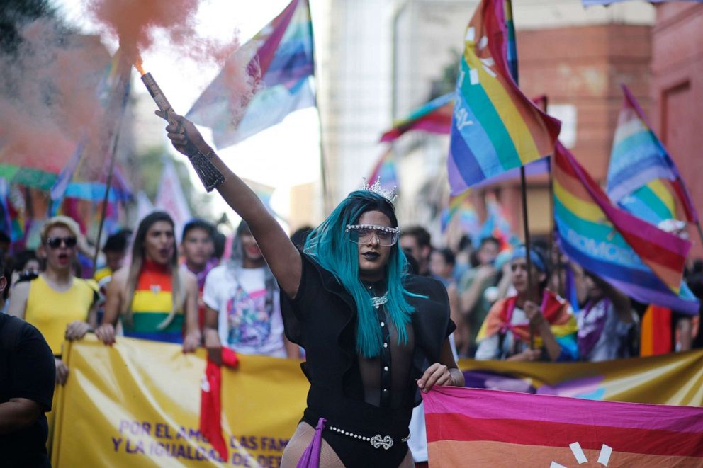 PHOTO: A trans woman holds a flare during the Gay Pride parade in Asuncion, Paraguay, June 29, 2019.